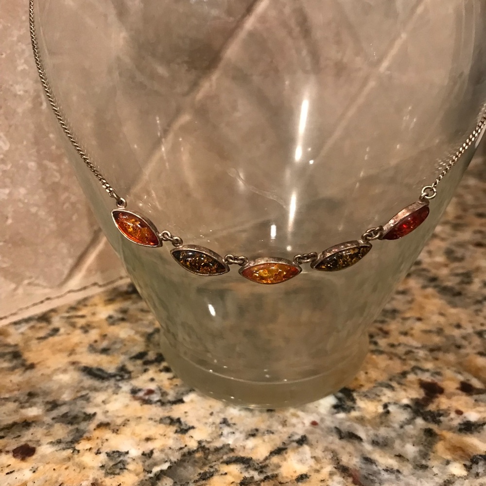 Multicolored amber necklace on silver chain.